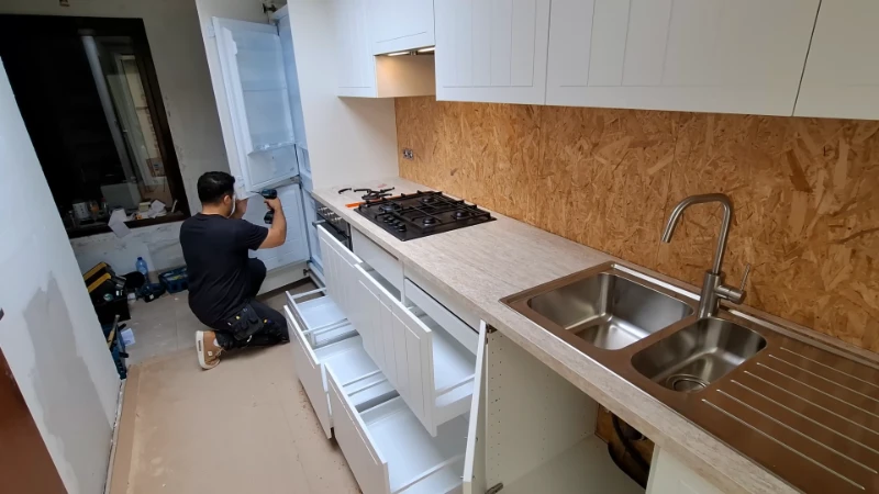 Close-up detail of precise cabinet alignment, tile installation, and countertop fitting in a quality kitchen remodel